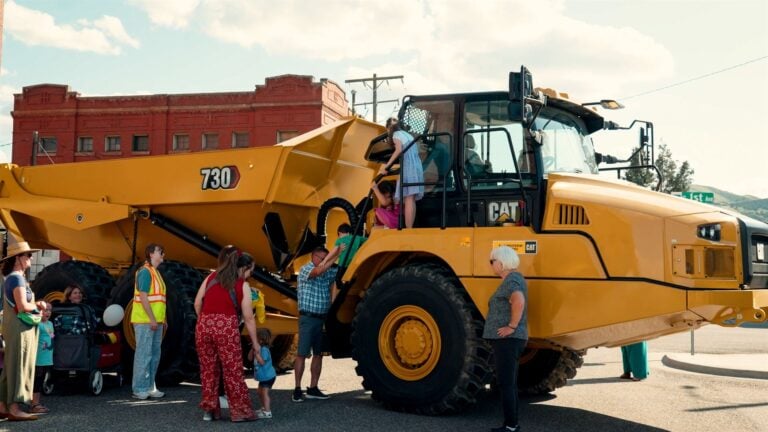 'Children climbing on construction trucks at Touch-a-Truck event in Pocatello Idaho